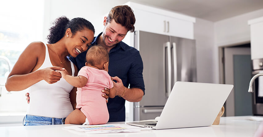 Smiling couple log in to the IBX member portal on laptop