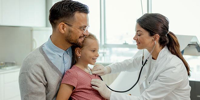 Father and daughter visiting doctor